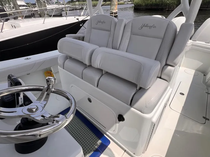  Yacht Photos Pics 2020 Yellowfin 36 boat interior with plush seating and sleek steering wheel.