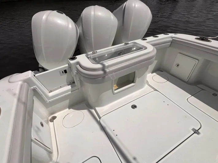  Yacht Photos Pics 2020 Yellowfin 36 boat deck with triple outboard engines and storage compartments.