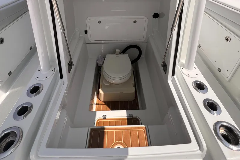  Yacht Photos Pics 2020 Yellowfin 36 boat interior with compact marine toilet and storage compartments.