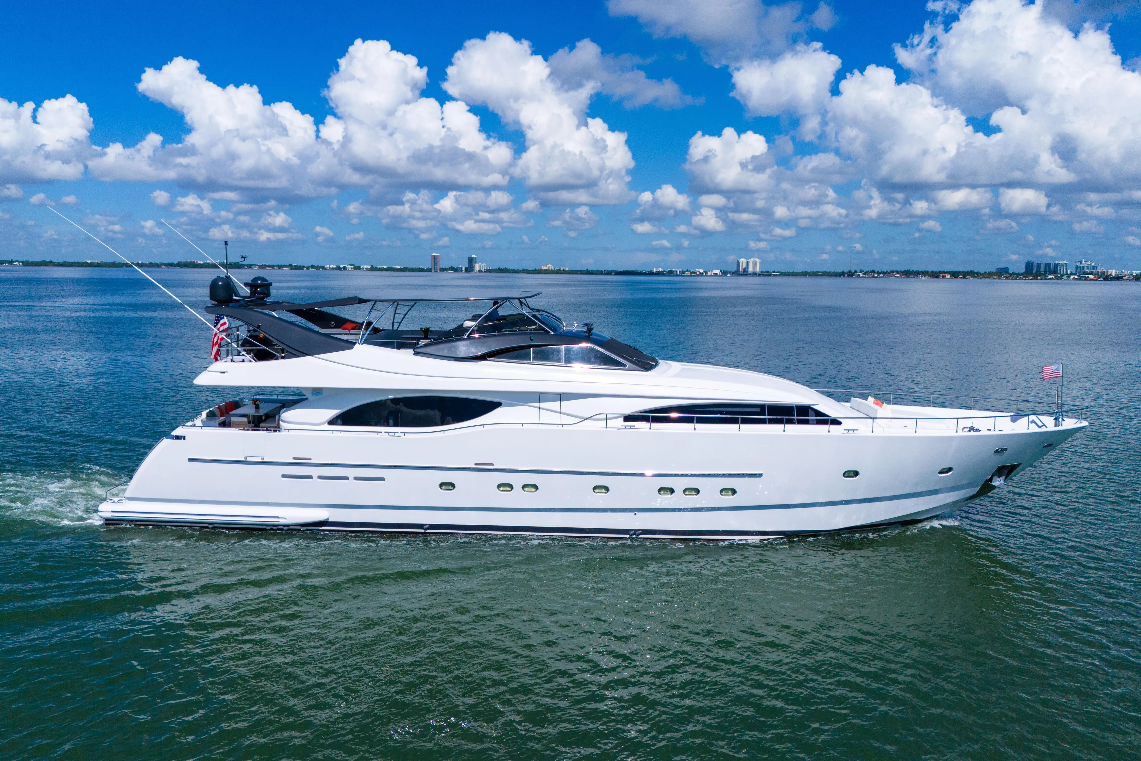 Sinpatico Yacht Photos Pics Luxurious 2002 Ferretti Yachts Custom Line 94 cruising on open water under a blue sky.