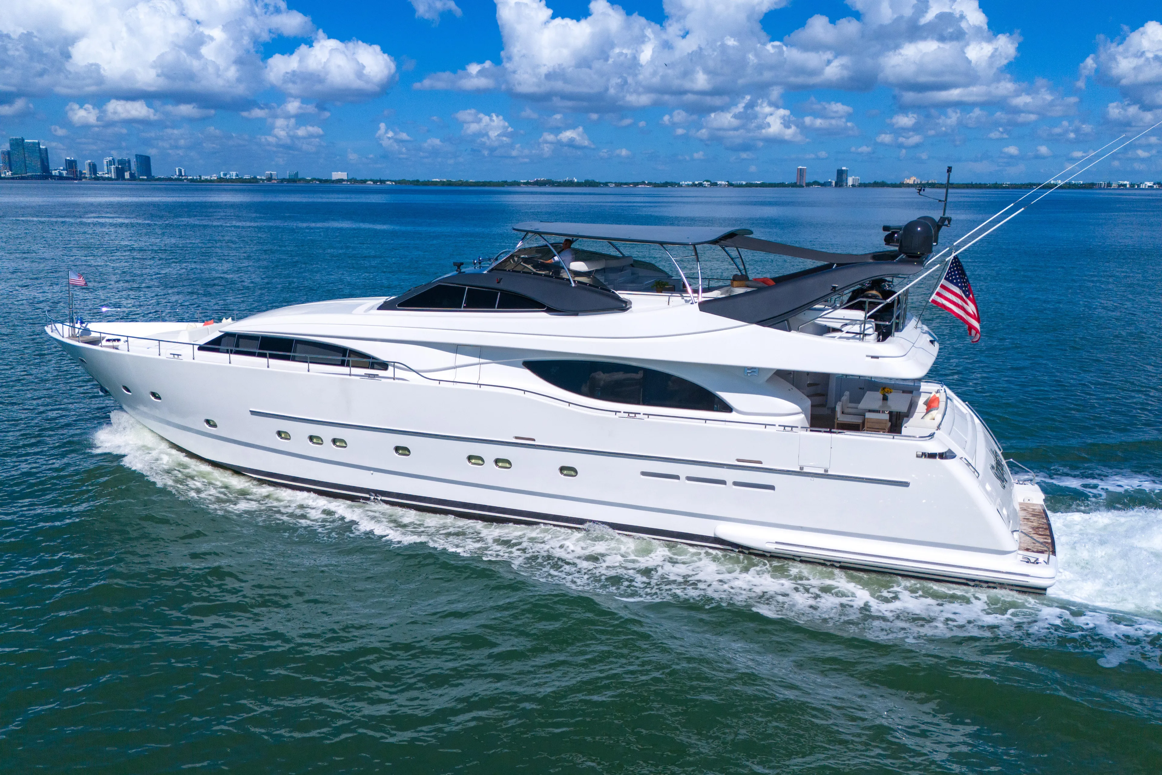 Sinpatico Yacht Photos Pics Luxury 2002 Ferretti Yachts Custom Line 94 cruising on open water under blue skies.