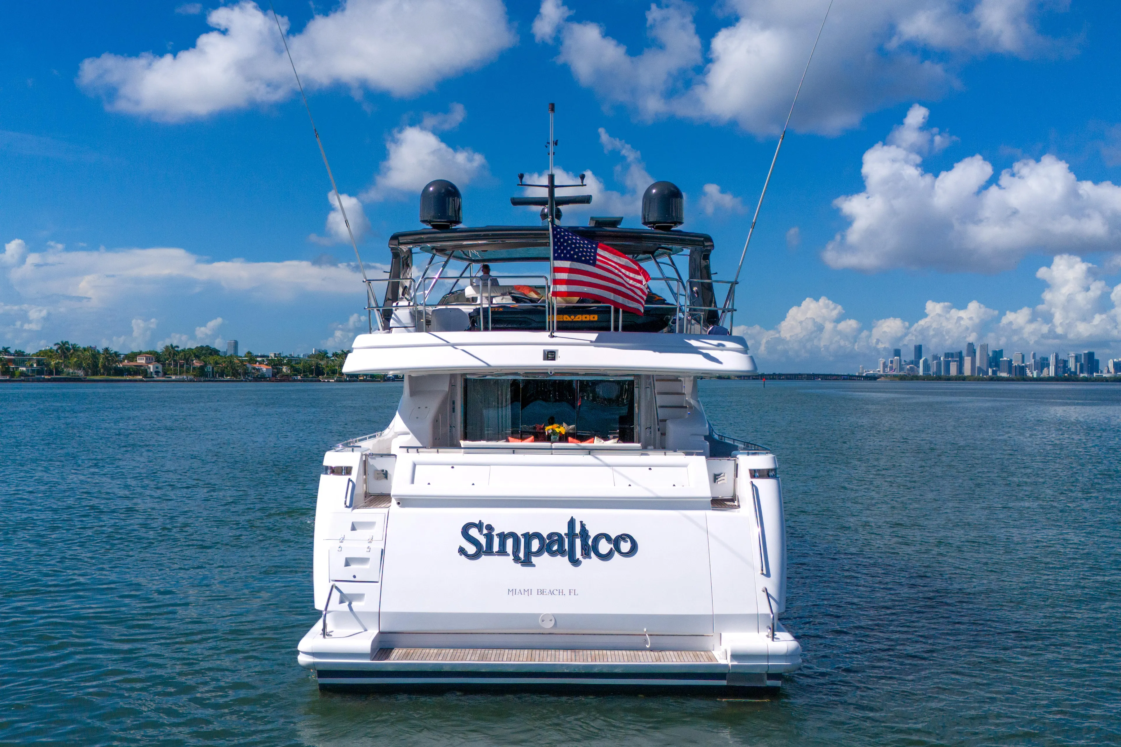 Sinpatico Yacht Photos Pics Ferretti Yachts Custom Line 94, 2002 model, docked with city skyline in background.