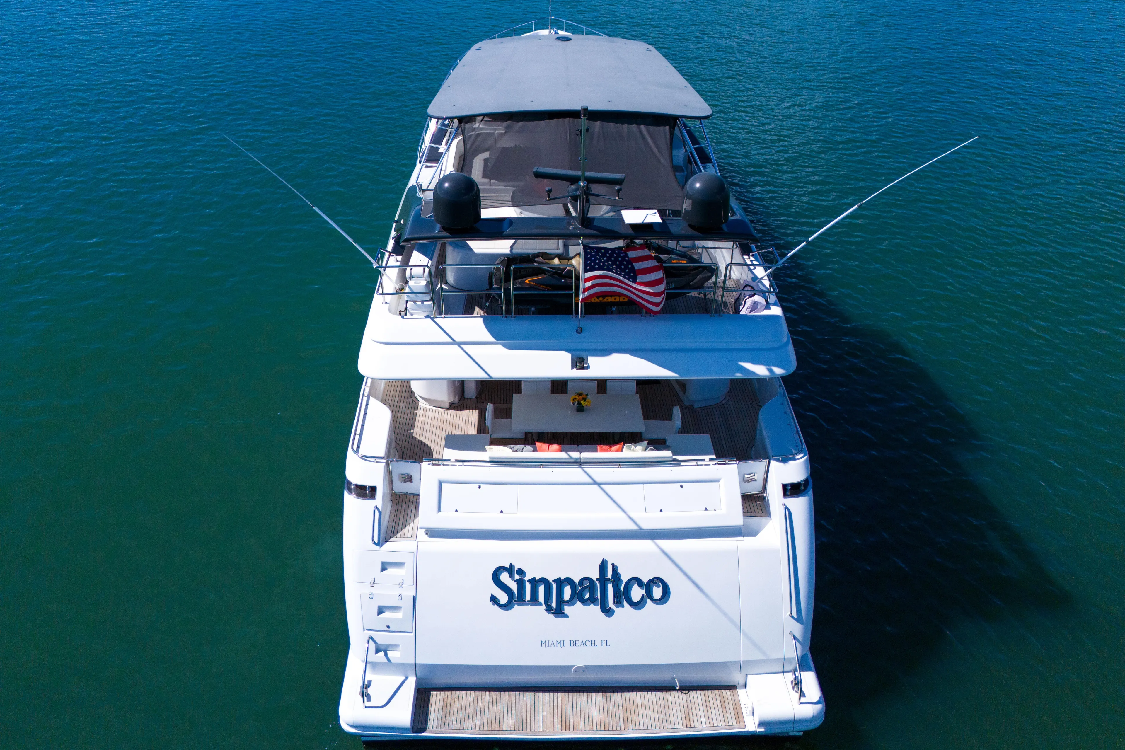 Sinpatico Yacht Photos Pics Ferretti Yachts Custom Line 94, 2002 model, docked with American flag, aerial view.