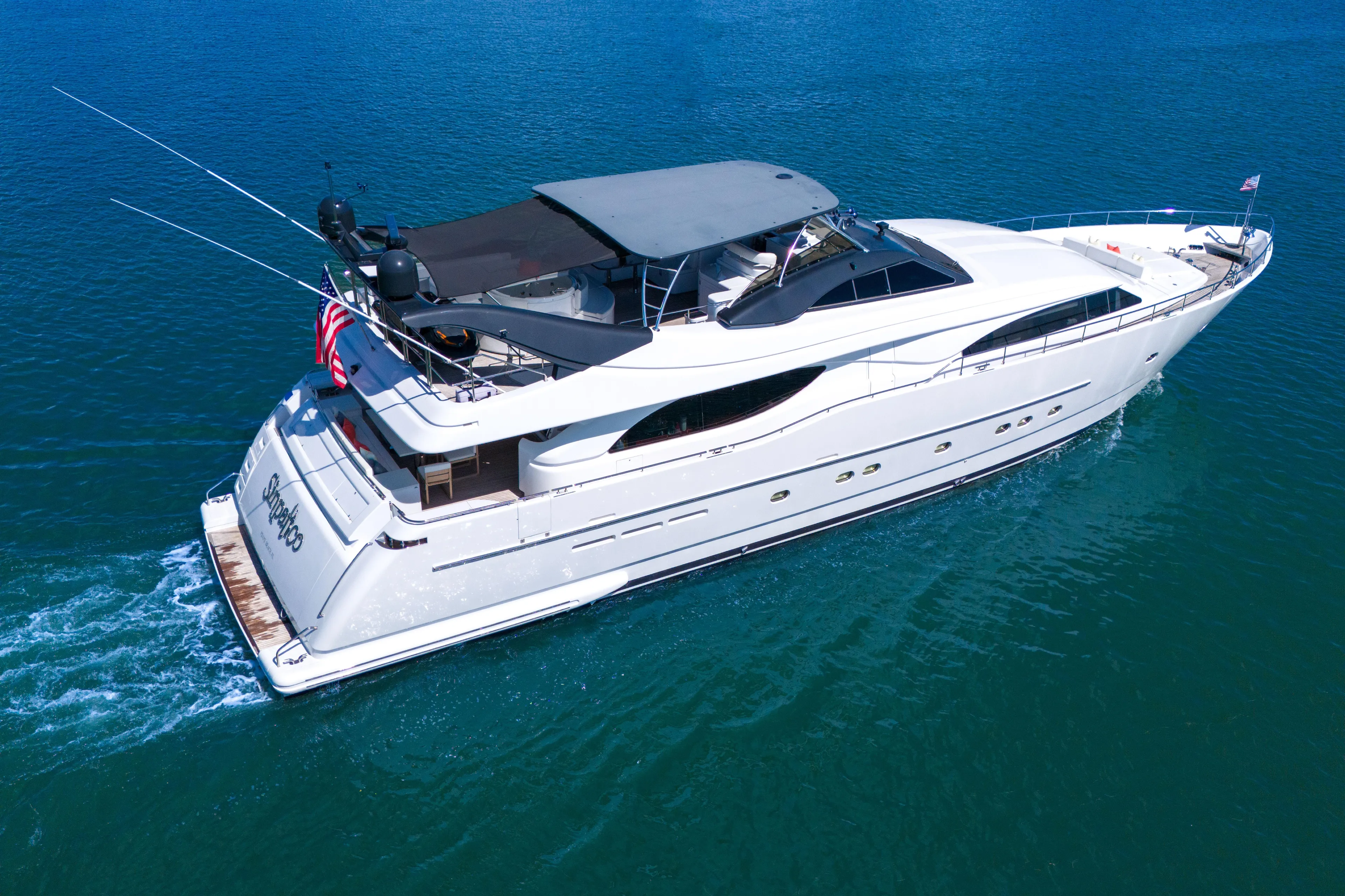 Sinpatico Yacht Photos Pics Luxurious 2002 Ferretti Yachts Custom Line 94 cruising on clear blue waters.