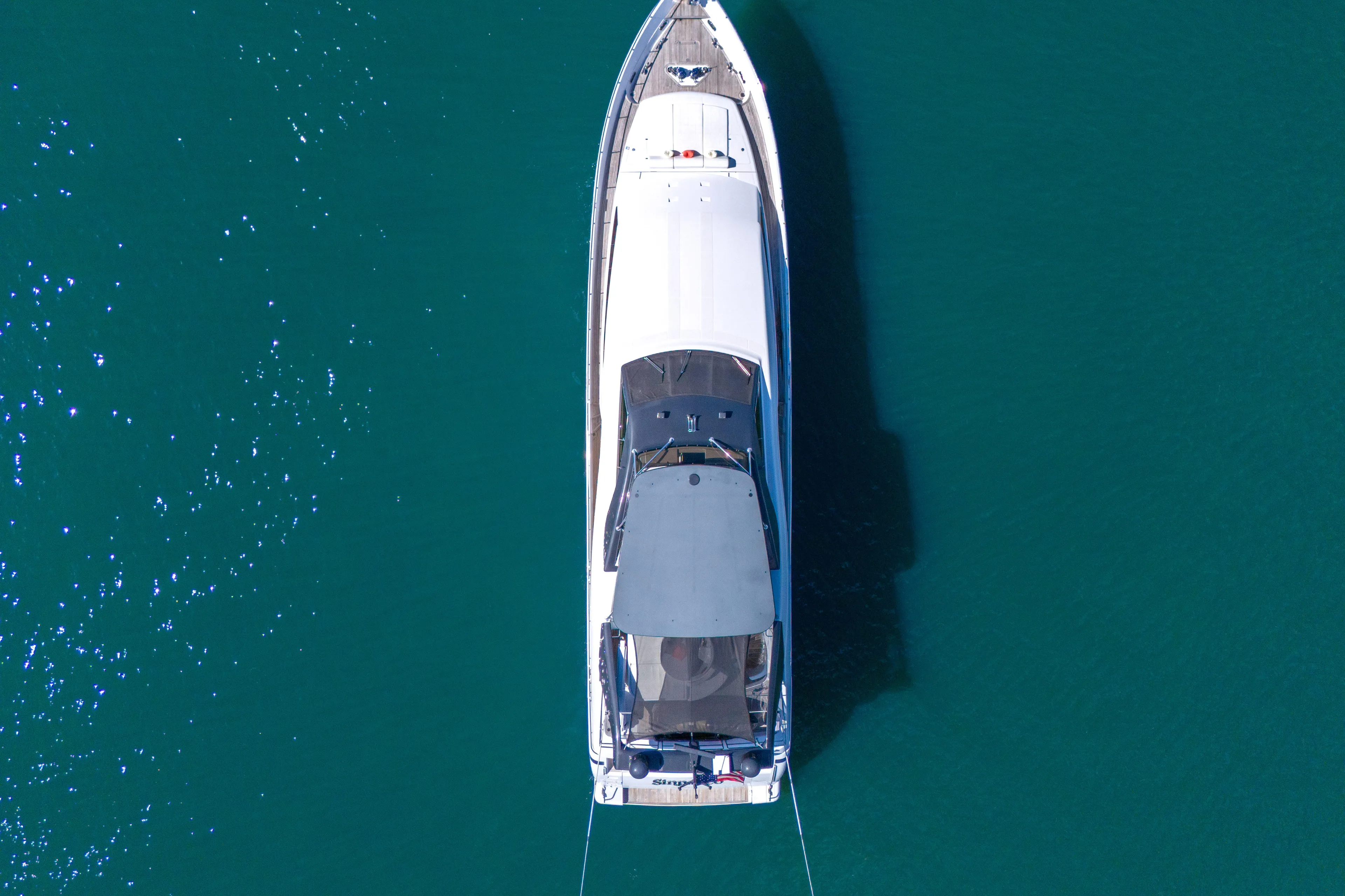 Sinpatico Yacht Photos Pics Aerial view of 2002 Ferretti Yachts Custom Line 94 on clear blue water.