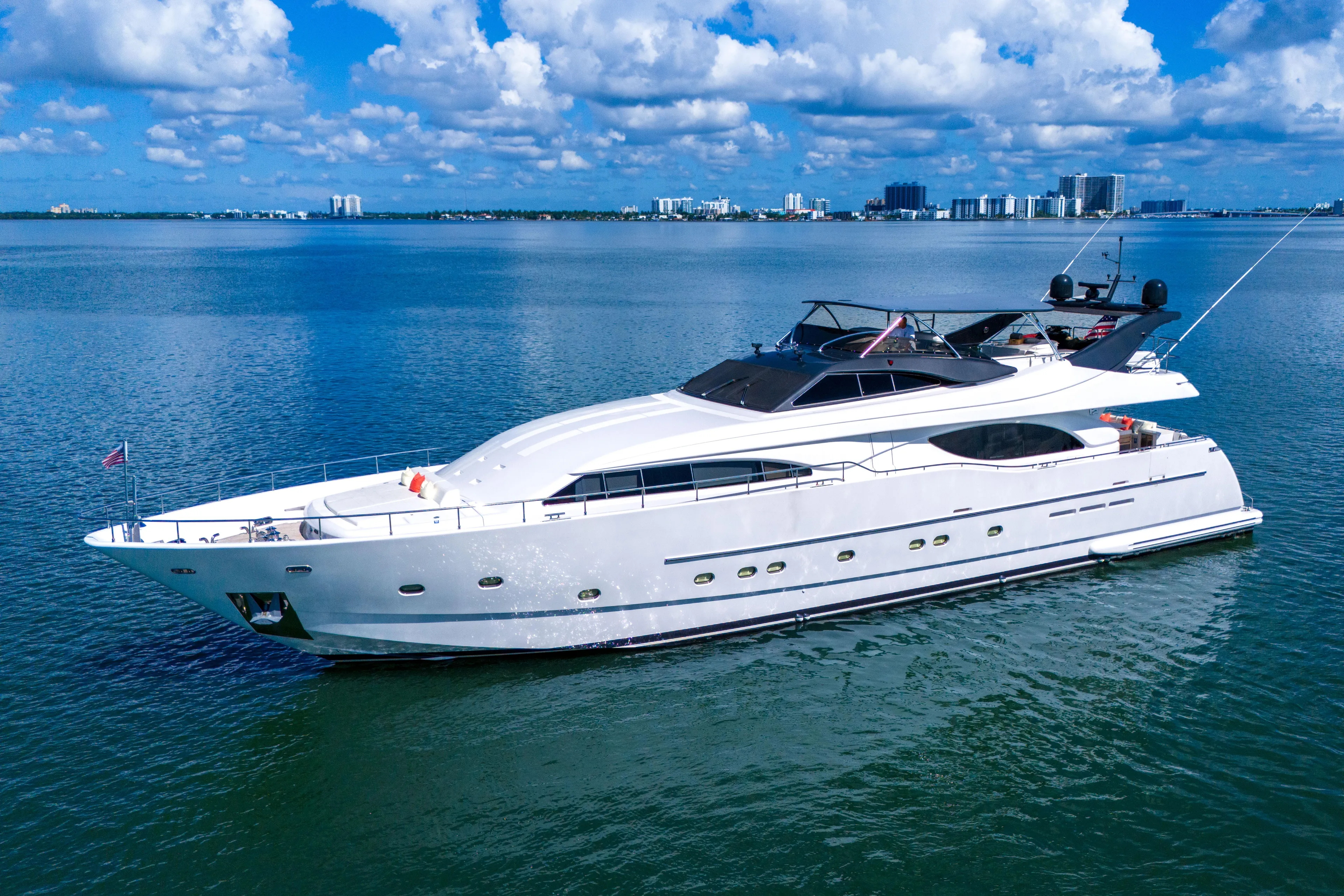 Sinpatico Yacht Photos Pics Luxurious 2002 Ferretti Yachts Custom Line 94 cruising on calm waters under a blue sky.