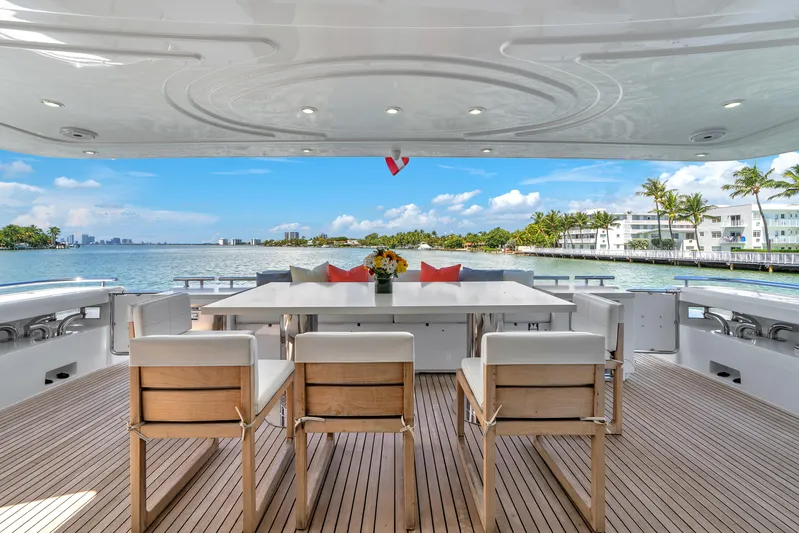 Sinpatico Yacht Photos Pics Luxurious 2002 Ferretti Yachts Custom Line 94 deck with elegant seating and scenic waterfront view.