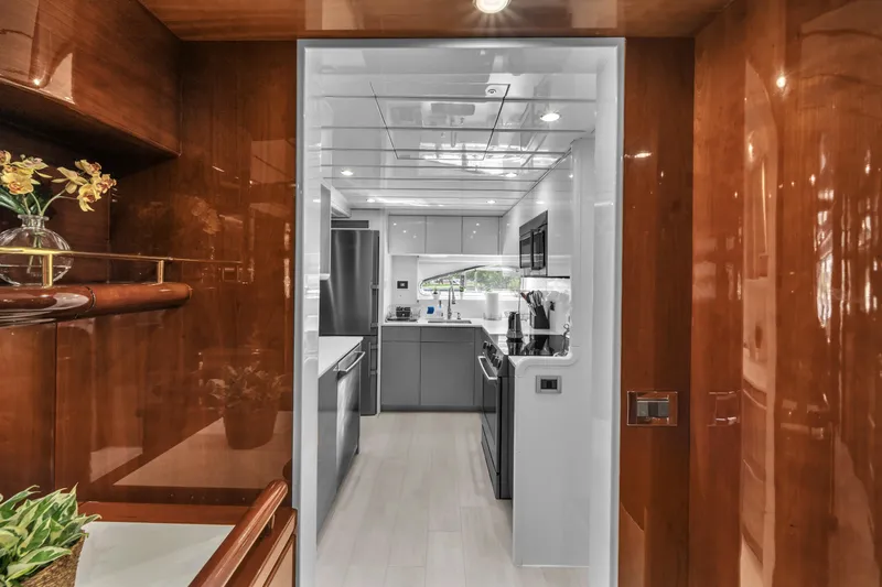 Sinpatico Yacht Photos Pics Luxurious kitchen interior of 2002 Ferretti Yachts Custom Line 94, featuring sleek cabinetry and modern appliances.