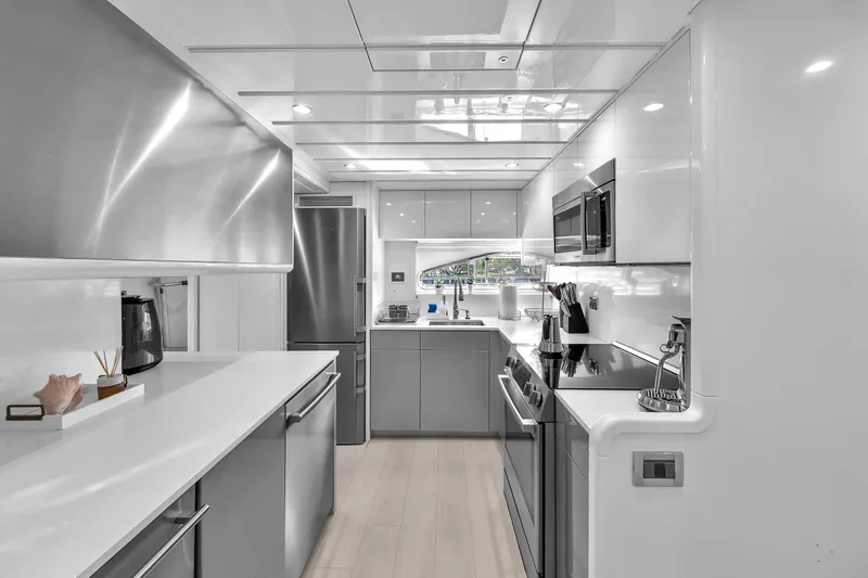 Sinpatico Yacht Photos Pics Luxurious modern kitchen in 2002 Ferretti Yachts Custom Line 94, featuring sleek stainless steel appliances.