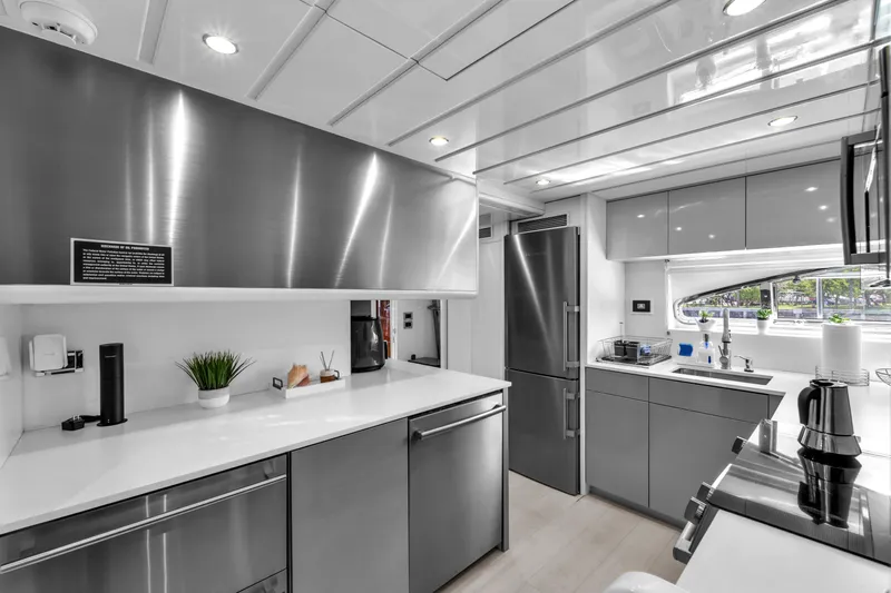 Sinpatico Yacht Photos Pics Modern kitchen interior on 2002 Ferretti Yachts Custom Line 94, featuring sleek stainless steel appliances.