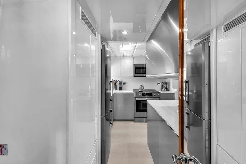 Sinpatico Yacht Photos Pics Modern kitchen interior on 2002 Ferretti Yachts Custom Line 94, featuring sleek appliances and cabinetry.