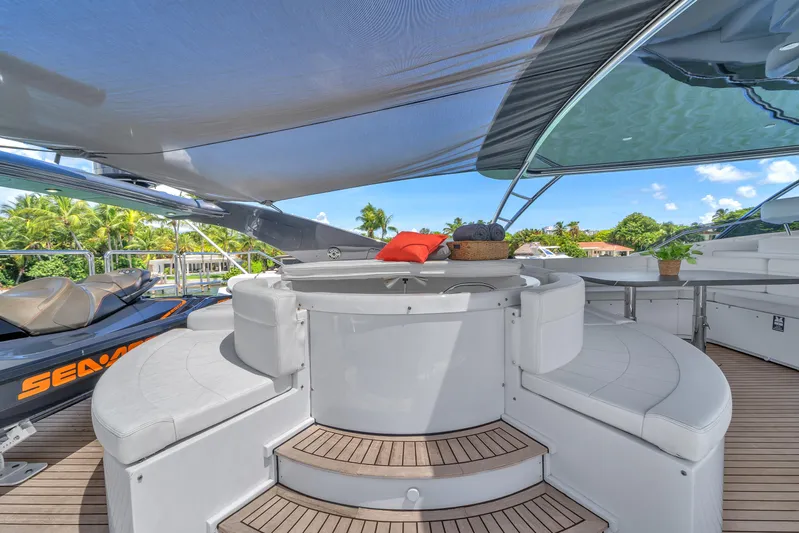 Sinpatico Yacht Photos Pics Luxurious 2002 Ferretti Yachts Custom Line 94 deck with seating, shade, and Sea-Doo jet ski.
