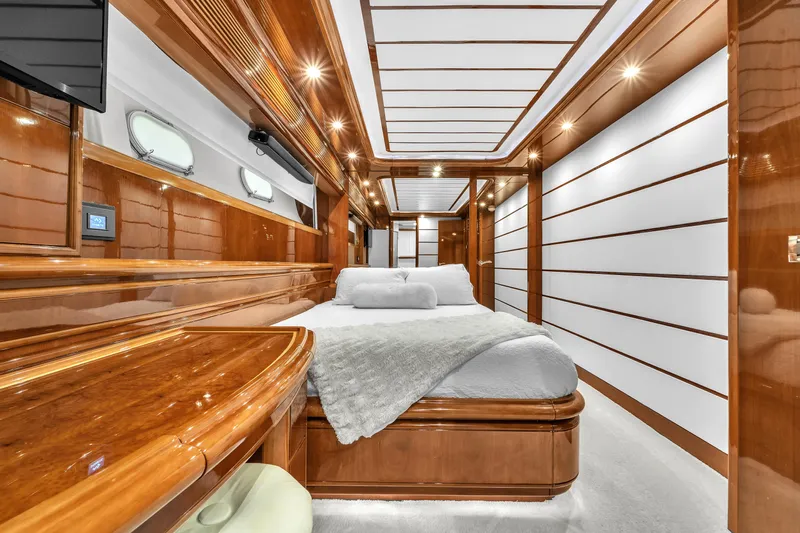 Sinpatico Yacht Photos Pics Luxurious bedroom interior of 2002 Ferretti Yachts Custom Line 94, featuring elegant wood finishes.