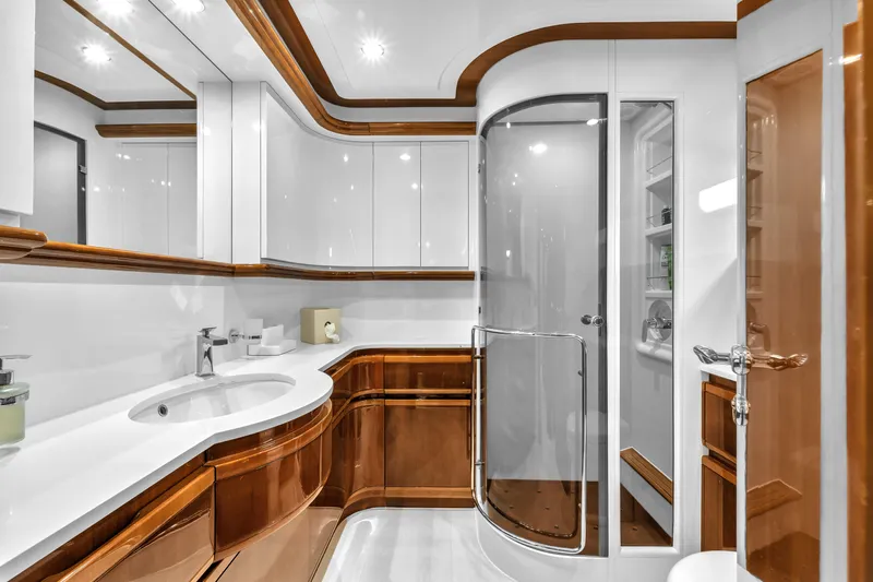 Sinpatico Yacht Photos Pics Luxurious bathroom in 2002 Ferretti Yachts Custom Line 94, featuring elegant wood accents and modern fixtures.