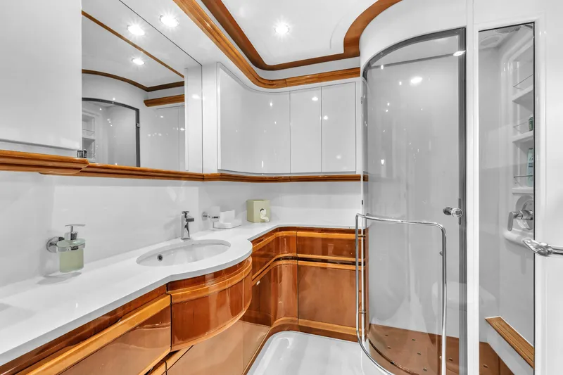 Sinpatico Yacht Photos Pics Luxurious bathroom on 2002 Ferretti Yachts Custom Line 94, featuring elegant wood and modern fixtures.