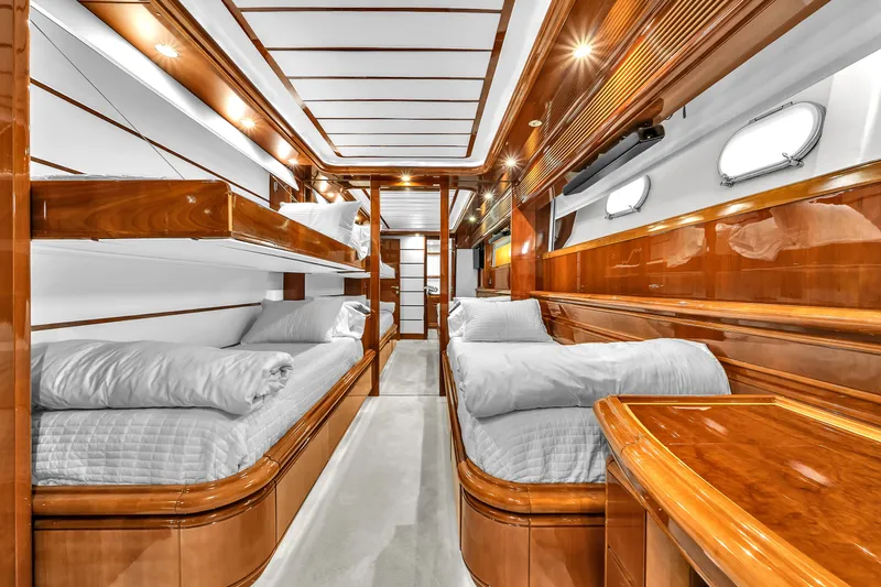 Sinpatico Yacht Photos Pics Luxurious cabin interior of 2002 Ferretti Yachts Custom Line 94 with wooden finishes and cozy beds.