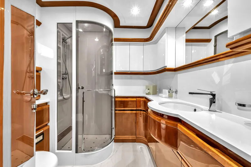 Sinpatico Yacht Photos Pics Luxurious bathroom on 2002 Ferretti Yachts Custom Line 94, featuring elegant wood and modern fixtures.