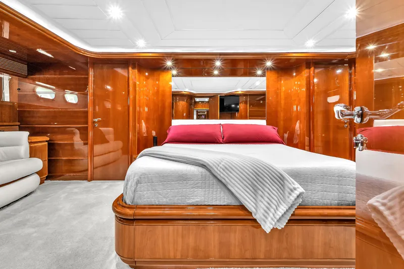 Sinpatico Yacht Photos Pics Luxurious bedroom interior of 2002 Ferretti Yachts Custom Line 94 with elegant wood finishes.