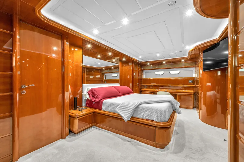 Sinpatico Yacht Photos Pics Luxurious bedroom interior of 2002 Ferretti Yachts Custom Line 94, featuring elegant wood finishes.