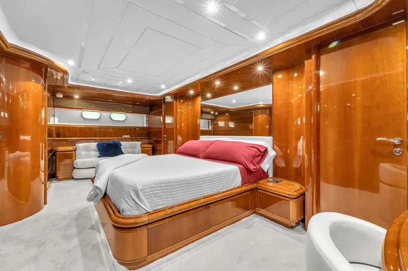 Sinpatico Yacht Photos Pics Luxurious bedroom interior of 2002 Ferretti Yachts Custom Line 94, featuring elegant wood finishes.