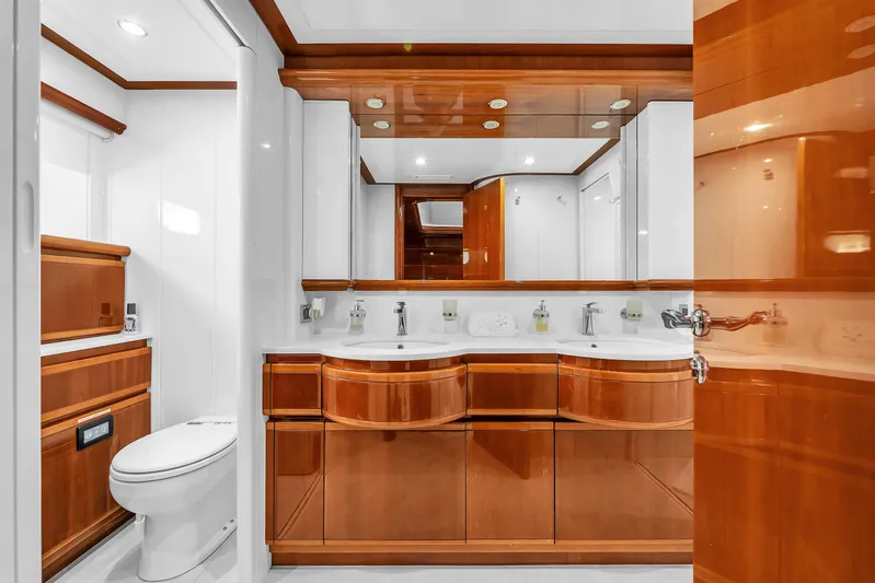 Sinpatico Yacht Photos Pics Luxurious bathroom on 2002 Ferretti Yachts Custom Line 94, featuring elegant wood cabinetry and modern fixtures.