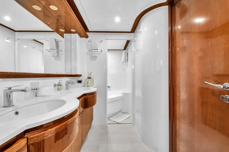 Sinpatico Yacht Photos Pics Luxurious bathroom on 2002 Ferretti Yachts Custom Line 94, featuring elegant wood and modern fixtures.