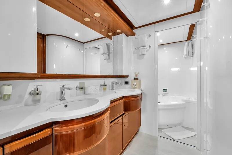 Sinpatico Yacht Photos Pics Luxurious bathroom on 2002 Ferretti Yachts Custom Line 94, featuring elegant wood cabinetry and modern fixtures.