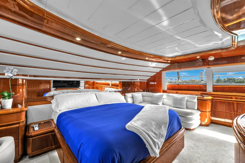 Sinpatico Yacht Photos Pics Luxurious bedroom interior of 2002 Ferretti Yachts Custom Line 94, featuring elegant wood finishes.