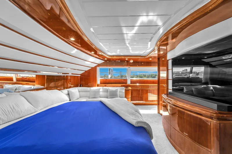 Sinpatico Yacht Photos Pics Luxurious bedroom interior of 2002 Ferretti Yachts Custom Line 94 with elegant wood finishes.