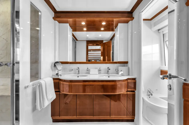 Sinpatico Yacht Photos Pics Luxurious bathroom in 2002 Ferretti Yachts Custom Line 94, featuring elegant wood finishes.