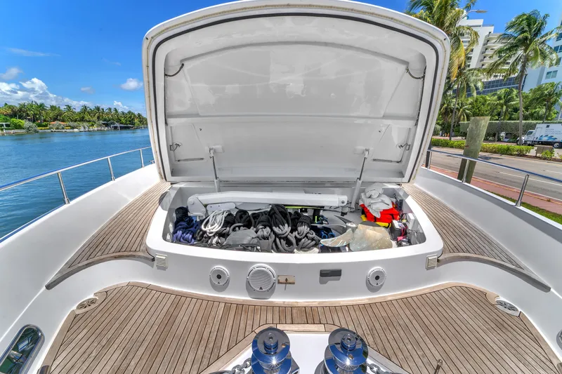 Sinpatico Yacht Photos Pics Open storage compartment on 2002 Ferretti Yachts Custom Line 94, docked by palm trees.