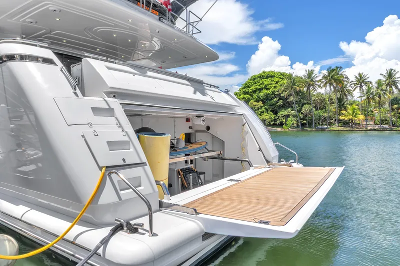 Sinpatico Yacht Photos Pics Luxury Ferretti Yachts Custom Line 94, 2002 model, docked by tropical shoreline.