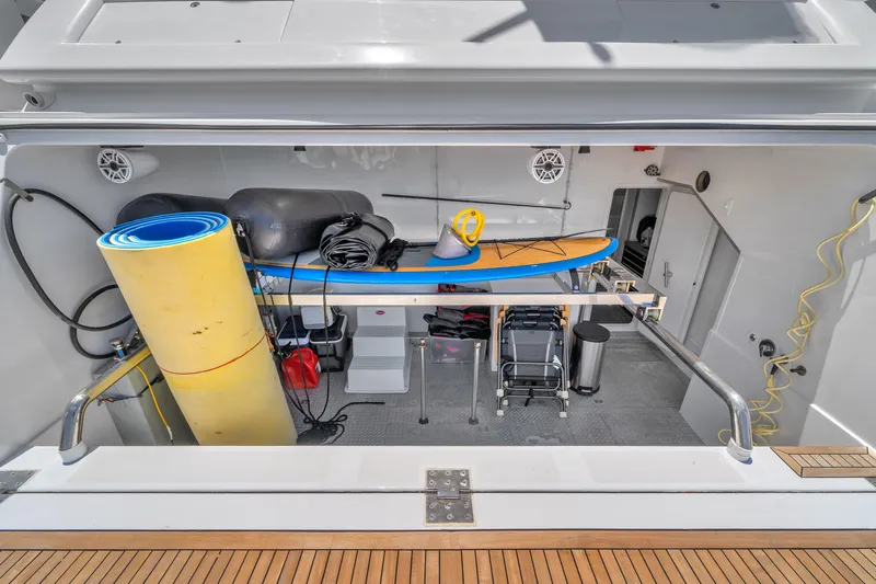 Sinpatico Yacht Photos Pics Storage area on a 2002 Ferretti Yachts Custom Line 94, featuring water sports equipment.