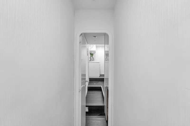 Sinpatico Yacht Photos Pics Narrow hallway inside 2002 Ferretti Yachts Custom Line 94, featuring sleek white walls.