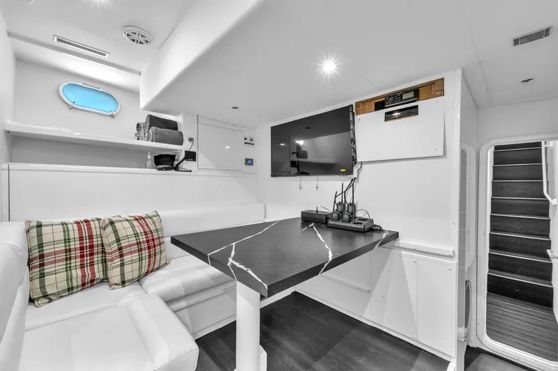 Sinpatico Yacht Photos Pics Luxurious interior of 2002 Ferretti Yachts Custom Line 94 with modern seating and table.