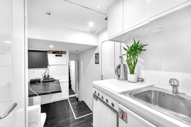 Sinpatico Yacht Photos Pics Modern kitchen interior on 2002 Ferretti Yachts Custom Line 94, featuring sleek design and appliances.