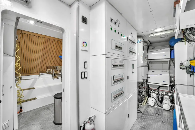 Sinpatico Yacht Photos Pics Engine room of 2002 Ferretti Yachts Custom Line 94, featuring control panels and equipment.