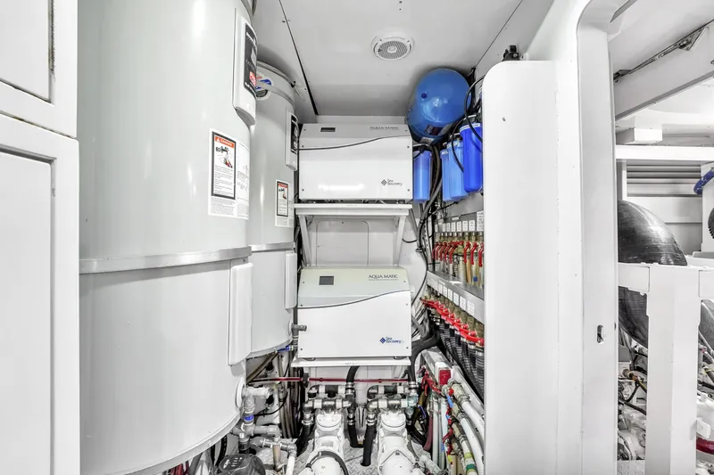 Sinpatico Yacht Photos Pics Engine room of 2002 Ferretti Yachts Custom Line 94, featuring water systems and equipment.