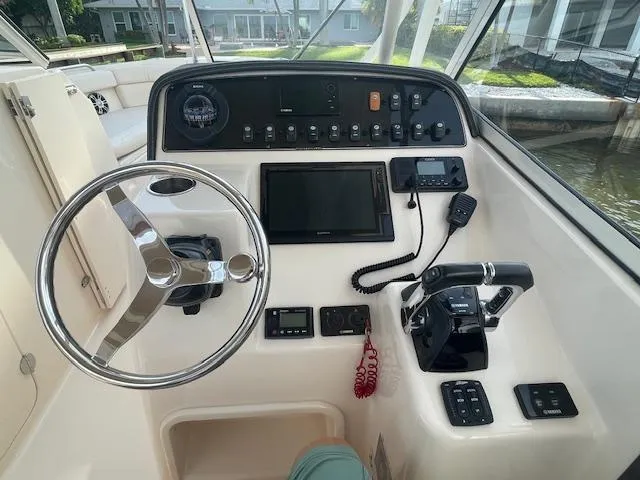  Yacht Photos Pics 2017 Grady-White Freedom 285 boat dashboard with steering wheel and control panel.