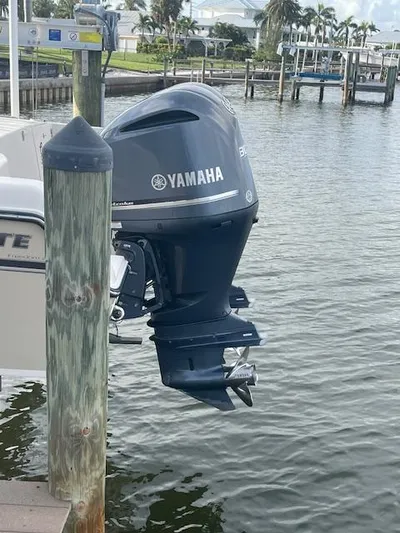  Yacht Photos Pics Outboard motor on 2017 Grady-White Freedom 285 boat docked by water.