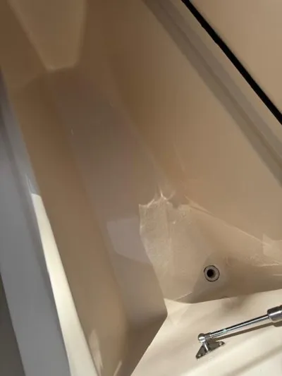  Yacht Photos Pics 2017 Grady-White Freedom 285 boat interior, featuring a clean, beige compartment with a metal fixture.