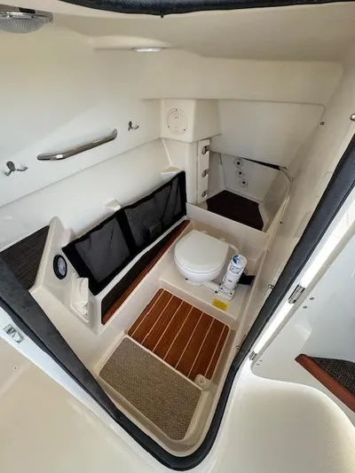  Yacht Photos Pics 2017 Grady-White Freedom 285 boat interior with toilet and storage compartments.