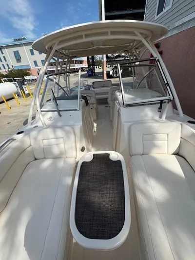  Yacht Photos Pics 2017 Grady-White Freedom 285 boat interior with seating and helm, docked outdoors.