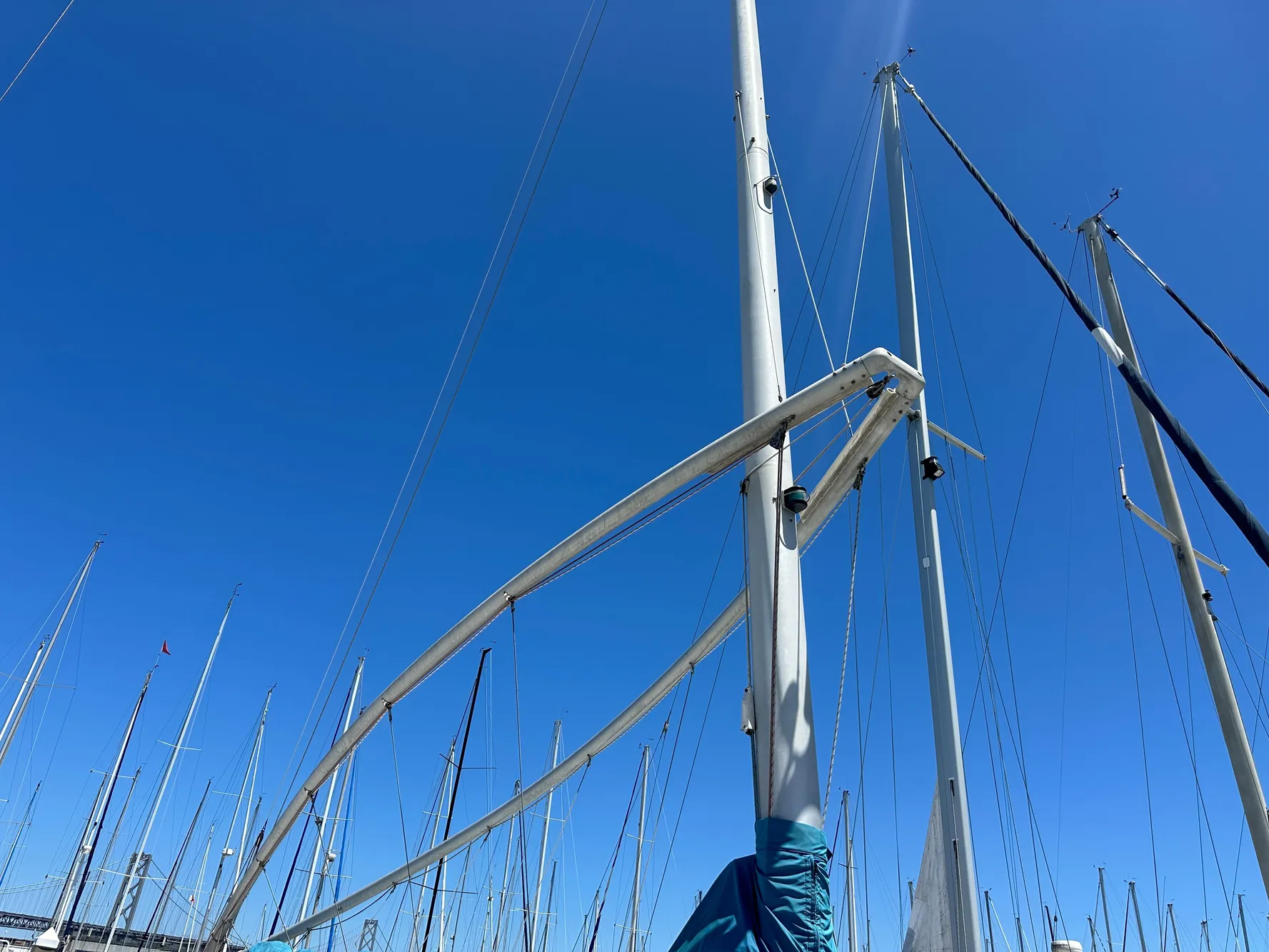 Sailboat mast of 1986 Nonsuch Ultra against clear blue sky.