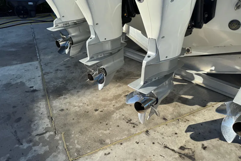 Millennium Falcon Yacht Photos Pics 2023 Formula 400 Super Sport Crossover boat engines with propellers on concrete surface.