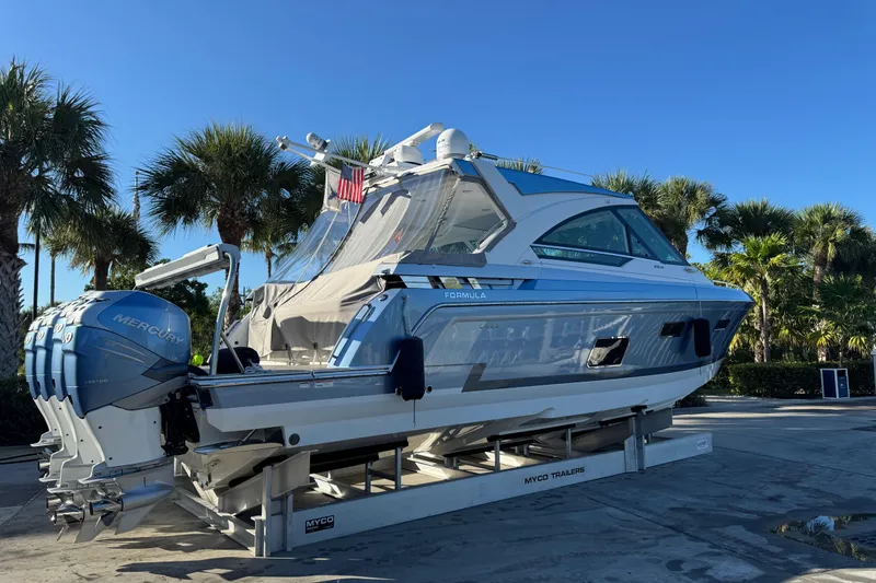 Millennium Falcon Yacht Photos Pics 2023 Formula 400 Super Sport Crossover boat on trailer, surrounded by palm trees.