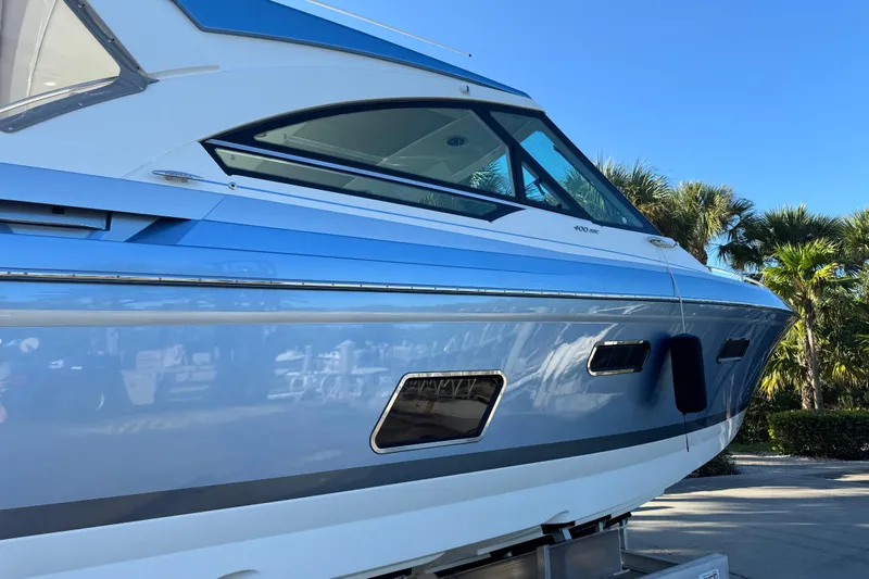 Millennium Falcon Yacht Photos Pics 2023 Formula 400 Super Sport Crossover boat, sleek design, blue and white exterior, sunny day.