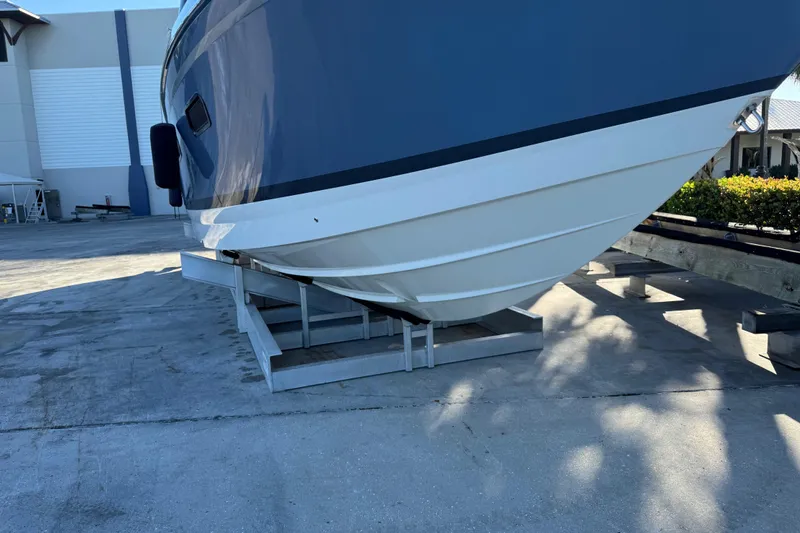 Millennium Falcon Yacht Photos Pics 2023 Formula 400 Super Sport Crossover boat on a support stand outdoors.