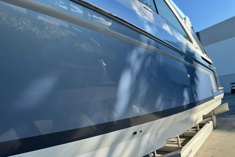 Millennium Falcon Yacht Photos Pics 2023 Formula 400 Super Sport Crossover boat, sleek blue exterior, docked under clear sky.