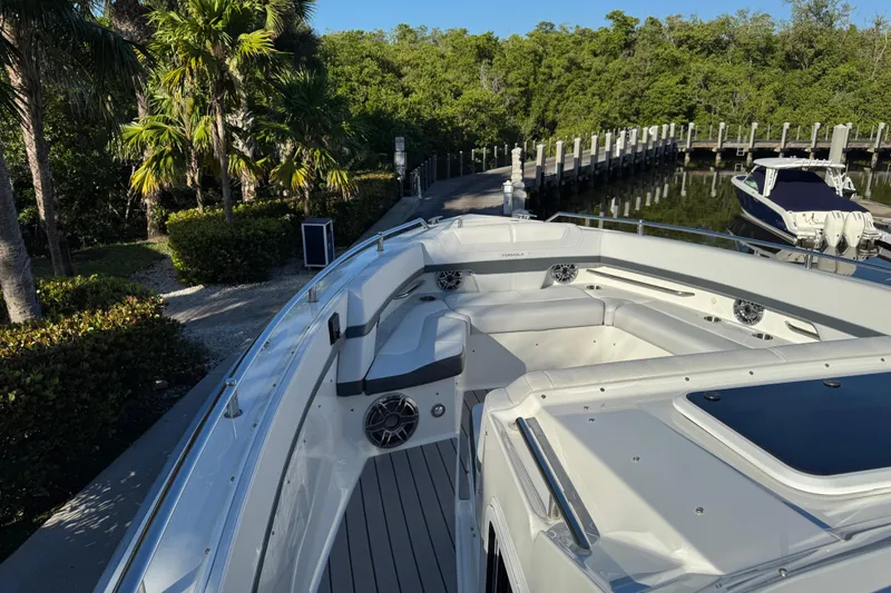 Millennium Falcon Yacht Photos Pics 2023 Formula 400 Super Sport Crossover boat docked near lush greenery.